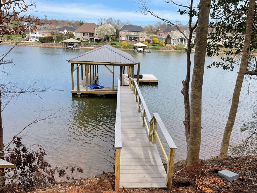 Looking for a lakefront property with BRAND NEW pier with covered dock and swim platform?  Look no further.  Lot 5 Windemere Isle  has just finished the construction of pier with covered dock and a swim platform.  The Island offers a private gated community with access to first come first serve boat/jet ski slips for daily use.  Amenities include; clubhouse, pool and tennis.  Boat and RV storage areas.  The lot is best suited for a basement style home.  Don’t wait, come out to see the wonderful water views.  Minutes from Lake Norman State Park.