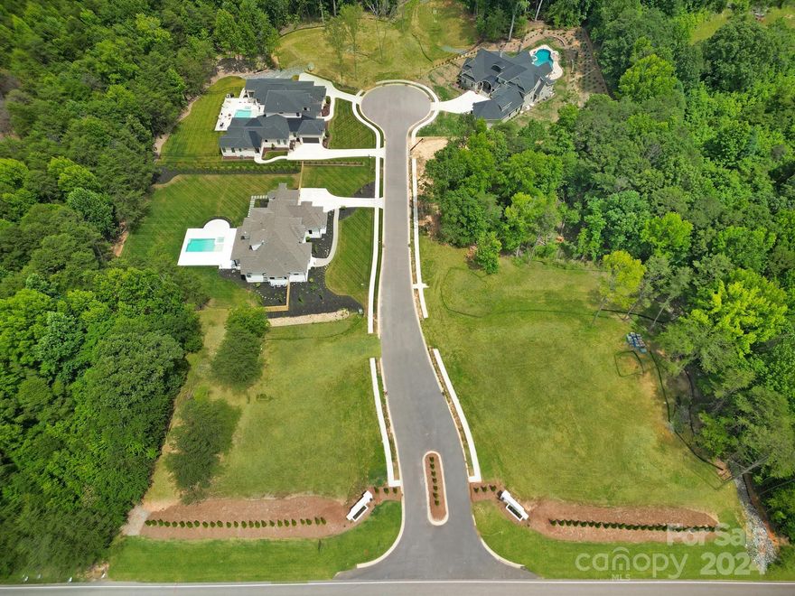 Welcome to Wisteria Meadows in Fort Mill, South Carolina.  This enclave of luxury offers seven one-acre lots on a beautiful cul-de-sac street named Wisteria Vines Trail.  Exclusive builder, OZ Custom Built Homes. The fashionable community is filled with opulent homes solely designed by architect, Sherman Wilson with distinctive design styles ranging from Classic European to Modern Farmhouse to Mediterranean. Three lots available. Lot 1 - above grade.  Lots 4 and 7 are full walkout basement lots.  Bring your own plan, choose or edit one of ours.  Beautifully situated in Fort Mill and conveniently located to Lake Wylie, Nivens Creek Landing, delicious eateries, shopping, schools and Interstate 77.