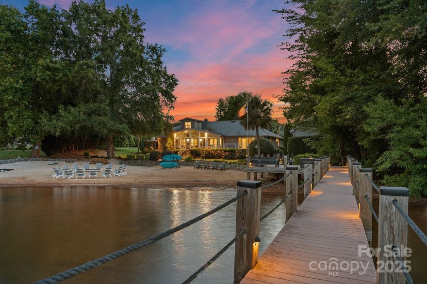 Stunning, renovated contemporary lakefront retreat on Lake Norman's west side! Featuring rare BIG-water views & one of the largest private beaches on the lake, the home is designed for effortless gatherings. The open-concept main level offers a beautifully-appointed kitchen with island seating, dining area, & a great room, providing a seamless flow for special occasions & everyday moments. When lake life beckons, kick up your heels & imagine you're outdoors in the three-season room, or venture outside to the expansive deck with hot tub; bask in the sun on the sandy beach, or take in the gorgeous sunset views. The main-level primary bedroom features private deck access & luxurious ensuite; 2 additional large bedrooms (one with an ensuite), a bunkroom with 3 built-in twin bunks, plus a huge upstairs bonus room with a spacious lounge. Detatched garage is perfect for a shop, or RV/boat storage, and is plumbed for a half-bath. Potential for a pool. Your Lake Norman dream getaway awaits!