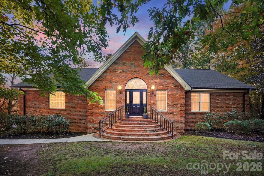 Charming Secluded Retreat in Fort Mill – Your Private Oasis Awaits!

Discover a rare gem tucked beneath a canopy of mature trees on a private, gated, and fully fenced 1.68-acre corner lot. This remarkable full-brick home blends tranquility, beauty, and convenience in one unforgettable setting. It's truly move-in ready and perfectly positioned just moments from Historic Downtown Pineville, with effortless access to shopping, dining, the hospital, and I-77.

Step inside to find 4 bedrooms and 3.5 bathrooms, each bedroom offering its own spacious walk-in closet for exceptional storage. Primary bedroom on the main floor. The renovated primary bath and refreshed kitchen and bathrooms bring a fresh, modern feel to the home.

Two stunning fireplaces anchor the living space, one in the bright and airy upper-level Great Room, and another in the cozy Walkout Basement Family Room which is ideal for quiet evenings or gatherings with loved ones.

With 1,310 additional sq. ft. of outdoor living, you’ll enjoy endless ways to take in the serene surroundings. Host dinners in the sunlit dining room, unwind on the expansive new Trex deck, relax on the covered patio, or sip a drink on the terrace while stargazing. Classic hardwood floors on the main level deliver timeless elegance, while new LVP flooring on the lower level adds durability and style.

A charming split system, heated and cooled shed, provides incredible flexibility. It's perfect for a studio, workshop, hobby space, or quiet getaway. Multiple outdoor areas frame picturesque views of the lush yard and the peaceful sound of a gentle fountain, creating the ideal backdrop for relaxation or unforgettable outdoor entertaining.

Peace of mind comes easy with a long list of significant recent upgrades, including a new architectural shingle roof (2025), new HVAC for the main level (2025), new Trex deck, new gate motors, and new garage door opener.

Best of all—NO HOA! Enjoy the freedom to personalize your property without added restrictions.

This exceptional home offers the perfect blend of privacy, modern comfort, and convenience. A peaceful haven in a truly unbeatable location. Don’t miss this rare opportunity! Schedule your tour today and experience the sanctuary you've been dreaming of.