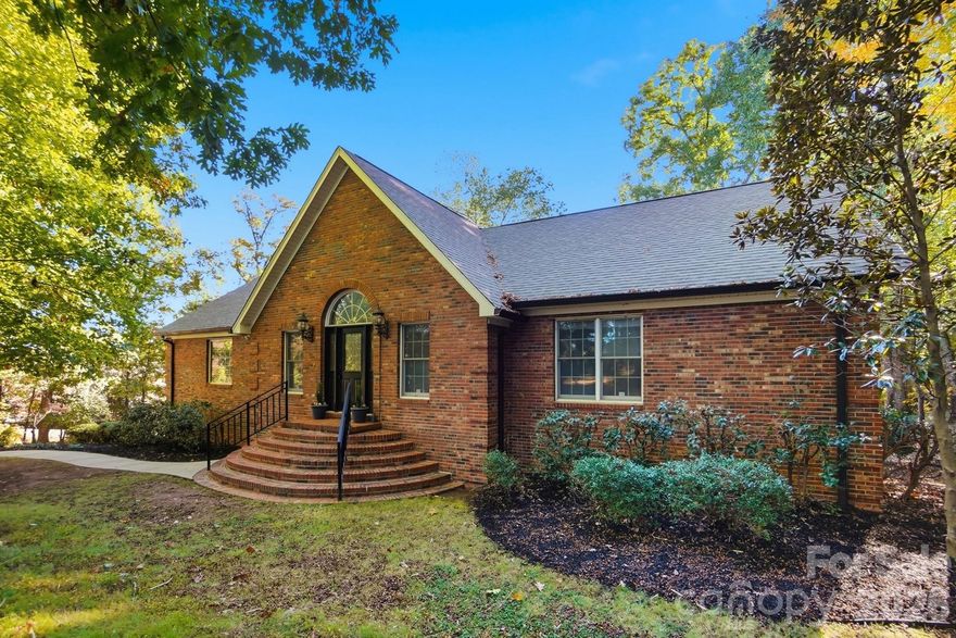 Charming Secluded Retreat in Fort Mill – Your Private Oasis Awaits!

Discover a rare gem tucked beneath a canopy of mature trees on a private, gated, and fully fenced 1.68-acre corner lot. This remarkable full-brick home blends tranquility, beauty, and convenience in one unforgettable setting. It's truly move-in ready and perfectly positioned just moments from Historic Downtown Pineville, with effortless access to shopping, dining, the hospital, and I-77.

Step inside to find 4 bedrooms and 3.5 bathrooms, each bedroom offering its own spacious walk-in closet for exceptional storage. Primary bedroom on the main floor. The renovated primary bath and refreshed kitchen and bathrooms bring a fresh, modern feel to the home.

Two stunning fireplaces anchor the living space, one in the bright and airy upper-level Great Room, and another in the cozy Walkout Basement Family Room which is ideal for quiet evenings or gatherings with loved ones.

With 1,310 additional sq. ft. of outdoor living, you’ll enjoy endless ways to take in the serene surroundings. Host dinners in the sunlit dining room, unwind on the expansive new Trex deck, relax on the covered patio, or sip a drink on the terrace while stargazing. Classic hardwood floors on the main level deliver timeless elegance, while new LVP flooring on the lower level adds durability and style.

A charming split system, heated and cooled shed, provides incredible flexibility. It's perfect for a studio, workshop, hobby space, or quiet getaway. Multiple outdoor areas frame picturesque views of the lush yard and the peaceful sound of a gentle fountain, creating the ideal backdrop for relaxation or unforgettable outdoor entertaining.

Peace of mind comes easy with a long list of significant recent upgrades, including a new architectural shingle roof (2025), new HVAC for the main level (2025), new Trex deck, new gate motors, and new garage door opener.

Best of all—NO HOA! Enjoy the freedom to personalize your property without added restrictions.

This exceptional home offers the perfect blend of privacy, modern comfort, and convenience. A peaceful haven in a truly unbeatable location. Don’t miss this rare opportunity! Schedule your tour today and experience the sanctuary you've been dreaming of.