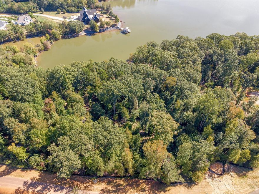 Waterfront and dockable homesite in McLean South Shore in Belmont NC on Lake Wylie. Lot 332 at 617 Waterton Trail is a gently sloping homesite in a wide cove on main channel. Lake views of broad cove and from potential home location will have views up the main channel looking east. Lot 332 offers a taller crawl or basement option. McLean South Shore offers walking trails, clubhouse, outdoor pool, fitness center, playground. Carolina Thread trail along Lake Wylie located across New Hope Road. Within minutes of grocery shopping - Publix and Harris Teeter. Plus minutes from the walkable City of Belmont with its quaint vibe, festivals, park, playground, active train line - kids love watching the train, restaurants and shopping. The bustling Charlotte Douglas airport is about 15 minutes away for easy travel access. Uptown Charlotte, South Park and Ballantyne are commutable via nearby highways. Great small town location at doorstep of a bigger city! Premier waterfront community!