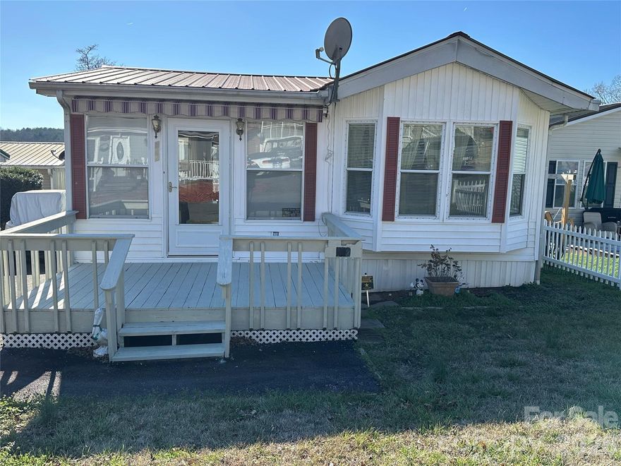 Lake life is calling! This charming 2-bedroom, 1.5-bath park model home with a stick-built room addition is located inside the gated waterfront community of Badin Shores Resort. Enjoy peaceful lake views while relaxing on the covered porch or back deck—perfect for morning coffee or relaxing after a day on the water. The bright room addition features a wall of windows that fills the space with natural light and flows seamlessly into the kitchen and dining area. The split-bedroom floor plan offers added privacy for visiting guests. A new heating and air system was installed in 2025, and the property is waiting for you to add your own updates and personal touches. Conveniently located near the marina, community restaurant, and boat ramp, you’ll have easy access to all the fun. Come experience the laid-back lake lifestyle and all the amenities (swimming pool, sandy beach, fishing pier, putt putt, playgrounds and more)Badin Shores Resort has to offer!