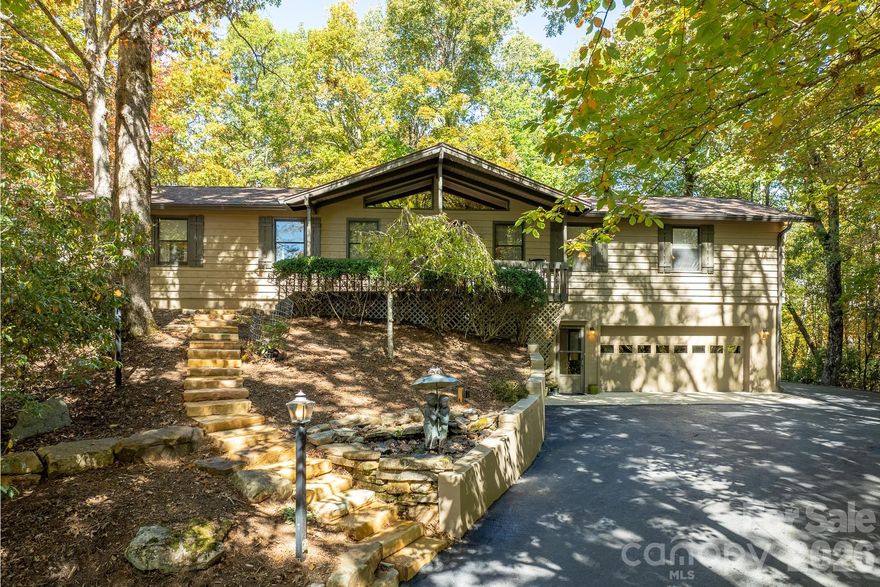 Welcome to a beautifully maintained Connestee Falls home offering nearly 4,000 square feet, seasonal mountain views, and an exceptional lifestyle in one of Western North Carolina’s premier gated communities. This 3-bedroom, 4.5-bath home combines comfort, flexibility, and value with features that are increasingly difficult to find at this price point. 
With two separate driveways, a double garage with work area, and a floor plan that allows for easy primary living on one level while offering spacious guest accommodations below, the home is well suited for both everyday living and hosting family and friends.
Inside, the home is in move-in-ready condition, with fresh interior paint, a newer roof, newer HVAC, and a new Trex deck. The kitchen is warm and inviting, featuring granite countertops, attractive cabinetry, and newer appliances. A sunroom adds bright additional living space, while the main level also includes a wet bar that enhances the home’s entertaining appeal. Two primary suites provide unusual flexibility, including one with a whirlpool spa tub for a private relaxing retreat.
Outside, the property is enhanced by extensive newer hardscaping, including Virginia river stone lining the driveways, flagstone walkways, and beautiful natural rock features that create a striking sense of arrival and reflect a substantial investment in the property. Set within Connestee Falls, owners enjoy access to a highly regarded golf course, four lakes, more than 20 miles of hiking trails, tennis courts, bocce, pickleball courts, a walking track, clubhouse amenities, two restaurants, swimming pool, and a newly completed wellness center with fitness facilities. 
The location is another major advantage, just a few miles from DuPont State Recreational Forest, Brevard, and Pisgah Forest, placing some of the best outdoor recreation, dining, and mountain living in Western North Carolina close at hand. For buyers seeking a spacious, well-kept mountain home with flexible living arrangements, beautiful outdoor improvements, and an unmatched community lifestyle, this property represents a rare opportunity.
This is one of the best values in Connestee Falls, priced below recent comparable sales, offering a rare combination of size, lot and location. There is a one-time amenities fee of $14,000, if paid at closing, to CFPOA. Enjoy one of the 10 best golf courses in North Carolina. If you’ve been waiting for a home that combines space careful maintenance, and value-this is it!