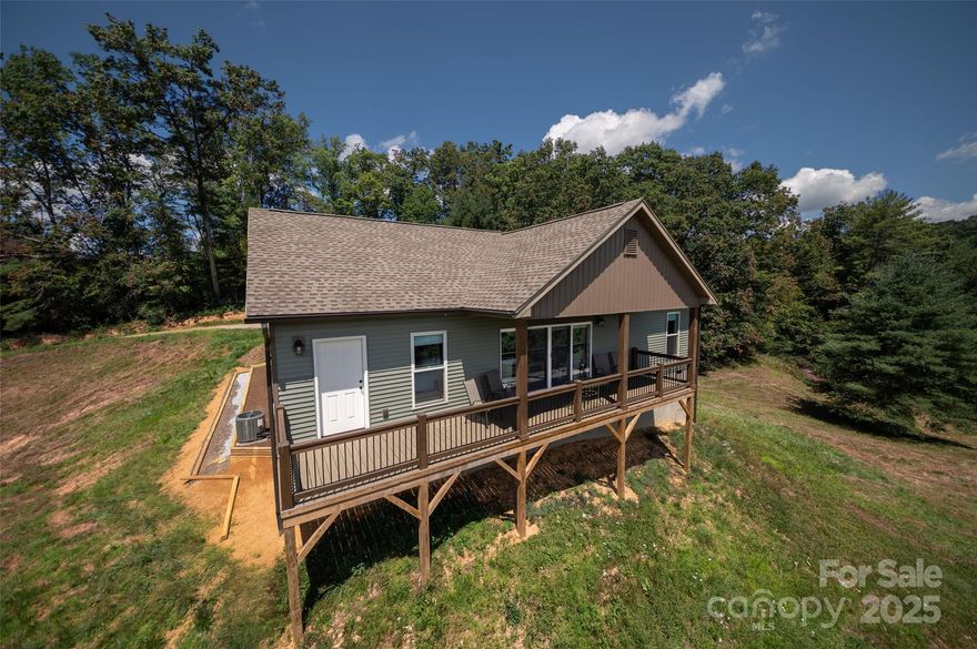 Majestic Mountain Top Property with a New House for Sale! Nearly 10 acres of secluded serene mountaintop property with stunning, unspoiled, high-elevation, scenic mountain views. The expansive ridges offer magnificent vistas of unsurpassed beauty. The main house viewing is south facing for many unobstructed miles. There are
breathtaking, uninterrupted views of two valleys that extend away from the house, one
towards the southeast, and the other towards the southwest. Both provide peace and solitude
for the abundant wildlife, like deer and turkey. The evenings can be filled with brilliant sunsets
offset by the dark mountains below. There are expansive outside spaces with room to grow and expand, with multiple prime building sites, with rolling to level terrain. There is already a large 2 room outbuilding, with
utilities and a buck stove. Already in place is a full hookup for an RV or trailer, with electric, water, and septic. The outbuilding has a full electric panel with enough power to put in an outdoor kitchen and entertainment area and can include a hot tub and spa. The house was newly built in October 0f 2024 and is comprised of 3 bedrooms, and 2 baths, with open plan living complete with vaulted ceiling and a fireplace, there is also a utility room, a pantry and a two-car garage. Close to schools and shopping, and only 30 minutes from Asheville. A recently improved internal road provides easy access to the top of the mountain. While words like "breathtaking," "serene," and "unrivaled" create a powerful image, they can’t
begin to describe the actual beauty of seeing it in person.