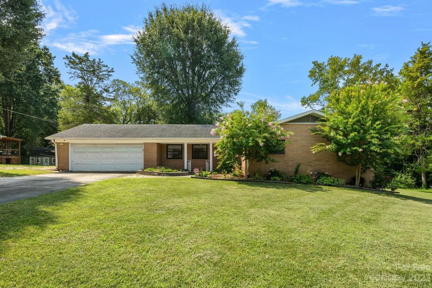 Step into this charming brick ranch featuring a 2-car garage. it not only has an outbuilding but boasts a heated/cooled 900 sqft workshop, complete with its own meter for convenience. The fully fenced backyard offers a cobblestone patio & covered back porch with pull-down sunshades, perfect for relaxing or entertaining. Offers just under 1800 sqft of living space for comfort and style. The heart of the home embraces a gas fireplace and built-in features, creating an inviting ambiance. The bathrooms showcase luxurious tiled walk-in showers, while the master bathroom also has a large jetted tub. Ample storage space and walk-in closets provide practicality. Flexibility is key with a den/living area that can easily transform into a fourth bedroom or versatile flex space to suit your needs. This home is fully equipped with security system for your peace of mind. This brick ranch is not just a home, but a sanctuary of possibilities. Don't miss the chance to make it yours.