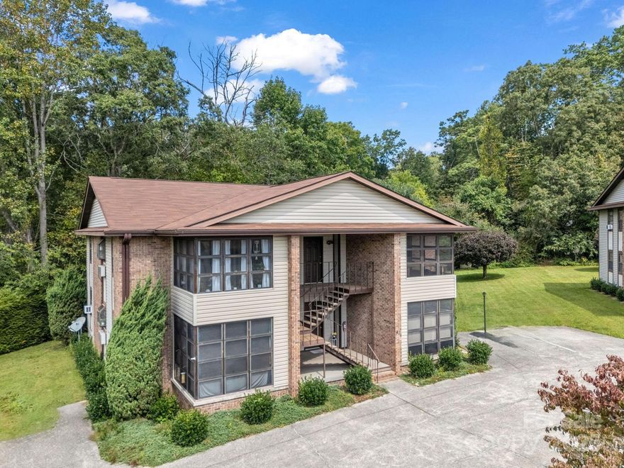 This exceptional 12-unit multifamily complex in Hendersonville presents a rare investment opportunity combining quality construction, meticulous maintenance, and long-term pride of ownership. Built and maintained by the original owner/developer, the property consists of three buildings, each with four spacious units—totaling twelve well-designed residences. Every unit features 2 bedrooms, 2 bathrooms, and a private sunroom, offering tenants comfort, functionality, and desirable living space that sets this property apart from typical multifamily offerings. Each building has been thoughtfully cared for and updated as needed over the years, reflecting the owner’s commitment to maintaining the property at the highest standard. The complex is fully connected to city water and city sewer and enjoys an ideal location just minutes from downtown Hendersonville, major retail, restaurants, and medical facilities, making it highly attractive to long-term renters. With consistent occupancy, low turnover, and proven rental history, this property provides an outstanding opportunity for both seasoned investors and those seeking to expand their portfolio with a stable, income-producing asset in one of Western North Carolina’s most desirable markets. The setting offers a balance of privacy and accessibility, with gently sloping terrain, paved access, and ample parking for residents. Each unit’s design emphasizes livability, featuring open-concept layouts, well-equipped kitchens, comfortable bedrooms, and bright sunrooms perfect for year-round enjoyment. The property’s thoughtful design—with only four units per building—ensures a sense of community while maintaining individual privacy and appeal. Opportunities like this rarely come available—an entire 12-unit complex in excellent condition, located in a strong rental market with city utilities, and ideal for investors seeking a well-maintained, turnkey property in a prime Hendersonville location.