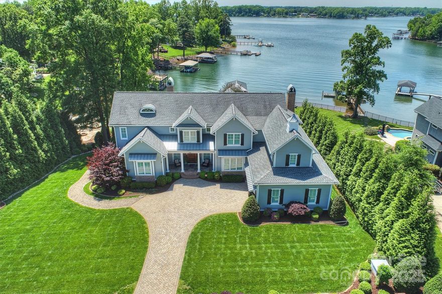 One of a Kind Lake Norman waterfront home on highly sought-after Brawley Peninsula. Unparalleled location w/a wall of windows & outdoor entertaining areas. Enjoy the freedom of No HOA or Restrictions! Nestled in a wide & deep cove in the center of the greater Lake Norman, it overlooks the main channel w/easy access to north & south LKN. This property was awarded Best Custom Waterfront Home in Lake Norman Home Builder's Association's Best of Lake Design Competition in 2018 & boasts numerous special features. With its uniquely designed plan & Lowcountry flair, this is a custom masterpiece! The home is very open, airy & light, featuring a beautiful Gourmet Kitchen w/a large island. Entertaining overflow onto the vaulted tongue & groove screened porch & covered outdoor grilling & fireplace area. Equisite mainlevel Primary offers views, door to porch & luxury bath including oversized step or roll-in shower, dressing area & closet. Upstairs, 3 ensuites & multiple bonus areas. Charm exudes!