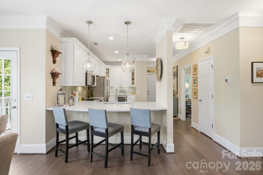An absolute peaceful, serene retreat, feels like a treehouse.  On the top floor with covered porches surrounding this very special condo, views of all natural areas, a pond and no shared walls.  This 2 Bedroom, 2 Bath Condo with 1 1/2 car garage, located perfectly & conveniently in the heart of Cornelius! A spacious, open floor plan with great natural light! Fresh paint throughout! Wide plank real hardwood maple floors throughout, crown molding in all main living areas and 7 1/2 inch height floor boards, gorgeous plantation shutters on all windows and all quarts countertops throughout.  Marble tiles in both baths, all new cabinetry throughout with soft close doors and drawers. Large Kitchen with all Kitchen Aid stainless steel appliances, Monogram wine cooler, glass tile back splash, plenty of cabinetry for storage, recessed lights, breakfast bar & pantry! Great Room with easy access to your expansive, covered deck to relax & unwind, while enjoying the mature landscaping & trees surrounding you! Spacious Primary Bedroom with sliding doors to outdoor deck, ceiling fan, private bath & walk in closet with elfa closet systems in both primary and second bedroom closet. Two columns of drawers in primary closet and one column of drawers in second bedroom closet! Primary Bath offers dual vanity, tiled shower & tile floors with frameless glass shower wall and door.  All updated lighting, plumbing fixtures and hardware, this condo has been fully updated and upgraded.  Edinburgh Square is a coveted, established community featuring a pool, club house, several greenway entry points & is located close to restaurants, shopping, entertainment, Jetton Park, Lake Norman & Birkdale Village!
