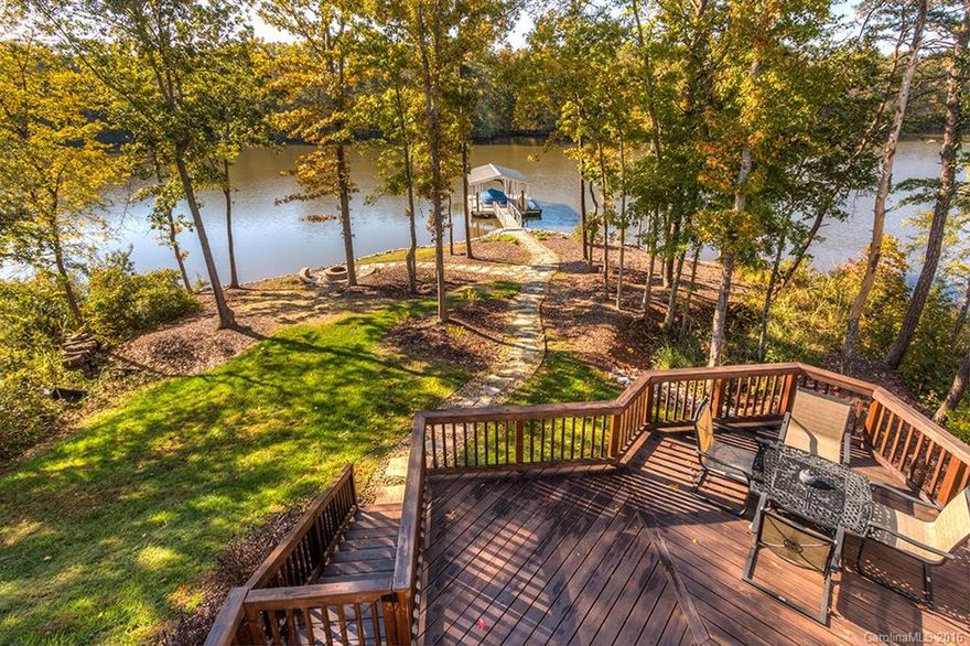 Are you looking for the ultimate lake house?  Check this out: 5 bedrooms with master suites on each floor. Gorgeous kitchen with granite & stainless against antique white cabinetry. Huge basement with a large open space suitable for a game room, billiard room, 2nd living room, or even all three at the same time. Outside you'll find a multi-level deck, covered aluminum boat slip with Trex decking, and a fire pit.  Whole house audio, full irrigation, and breathtaking views of the lake.