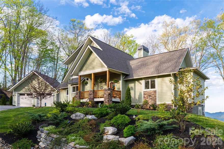 Some homes check the boxes. This one will change your life.

Walk through the door and the wall of windows finds you immediately. The Blue Ridge unfolds in long, layered vistas across every season, and the open-concept main level is oriented around that view the way every good room should be, light pouring in, the mountains always present, the whole space feeling larger and quieter than its square footage suggests. Bright without being stark. Elegant without being heavy. Custom quality evident in every finish, every proportion, every detail.

The floor-to-ceiling stone fireplace anchors the great room with the kind of presence that only natural materials and genuine craftsmanship can produce. It grounds the space without overwhelming it, and on a cool mountain evening with the ranges laid out beyond the glass, there is simply nowhere else you would rather be.

Main-level living here is genuinely effortless. The primary suite, living, dining, and kitchen all flow on one floor, perfectly scaled for the buyer who has decided that right-sizing should never mean giving anything up. The kitchen earns its place in that equation, appointed with custom cabinetry, marble countertops, and a generously sized pantry tucked discreetly out of the sightline.

Upstairs, two well-appointed guest bedrooms and a full bath offer comfortable, private space for family or visitors, along with a large dedicated storage closet. One guest room functions as an office with a view, featuring a built in murphy bed for versatility.

Then you step outside, and the home reveals its full hand.

The covered porch with its wood-burning fireplace is an extension of the living room in every sense, the same commanding view corridor now open to the sky, the air, and the sound of the ridge. As the light shifts across the ranges through the day and into evening, this is where you will find yourself. Beyond the porch, a dedicated firepit terrace offers its own equally spectacular views, a natural gathering place where the mountains feel close enough to reach. Three distinct fireplace experiences across the indoor and outdoor spaces, each one oriented toward one of the most compelling view corridors in Haywood County, and each one earning its place in a different way depending on the season, the mood, and the hour.

The primary suite opens privately to a dedicated hot tub area, a quiet luxury that transitions from amenity to daily ritual the moment you arrive. Enjoy your morning coffee with the mist lying still in the valleys and light cresting above the ridges. Sit back and relax in the evening under a sky full of stars. This home was designed to be lived in fully, and the outdoor spaces make that case as convincingly as anything inside.

The attached two-car garage connects via a covered breezeway offering maximum curb appeal and ample storage. Beautiful hardscaping and intentionally chosen landscaping offer year-round color and beauty at every turn. City water and AT&T Fiber Internet offer convenience and versatility. Hop in your golf cart and ride to Lake Junaluska in minutes to enjoy seasonal events, amazing walking trails, golf, and water sports. Historic downtown Waynesville and the region's finest trailheads are mere minutes away, while Asheville's vibrant dining and arts scene await only 30 minutes down the road.

Avalon is Waynesville's most coveted gated mountaintop community, a 400+ acre luxury enclave renowned for its privacy, mature hardwoods, walking trails, and timber frame pavilion, where custom homes of this caliber routinely trade well above two million dollars. This one is a rare exception, in like-new condition, at a price point this address seldom sees.

In Western North Carolina, unicorns are rare. This is one of them.