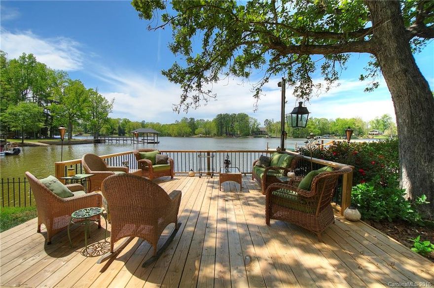 Lakefront living in the heart of Lake Wylie! Big open view, and outdoor living spaces galore: screened porch, covered porch, lakeside deck to relax by the water. Scenic lake views from the huge sunroom open to the kitchen and dining area. Flexible space with up to four bedrooms. Main level master has oversized whirlpool tub, walk-in shower. Kitchen has stainless appliances and center work island. Two bedrooms upstairs with deck. Lovely landscaping, nice level lot. Excellent Clover schools!
