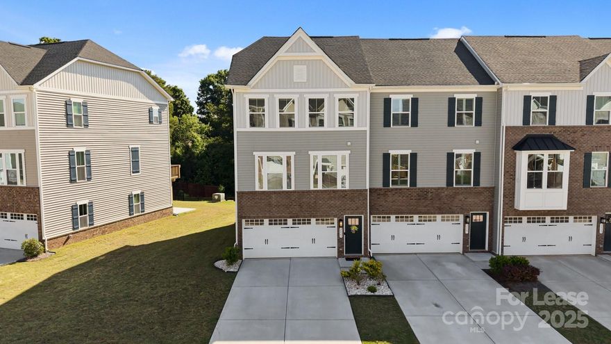 Welcome to this beautifully maintained end-unit townhome in a gated community nestled in the heart of Fort Mill. This end-unit with extra windows features a large side yard, private backyard w/ patio, and a scenic lake view perfect for entertaining, or simply relaxing in your own oasis. Epoxy finished 2 car gar and driveway space for 4 cars. 1st floor has a large rec room w/ LVP flooring & a sliding door to the backyard. The main floor w/ LVP flooring has an open floor plan. kitchen w/ extended island & quartz countertops and SS appliances. Dining area opens to the back deck with a beautiful pond view from the deck. The deluxe owner’s suite on the third floor features an oversized walk-in closet. Primary bath w/ dual sinks & upgraded shower. Two more large-sized BR located upstairs, 9’ ceilings on both upper floors. Award-winning Fort Mill schools, easy access to highways I-77, I-85, I-485. Community amenities include swimming pool, playground, tennis, pickleball and basketball courts.