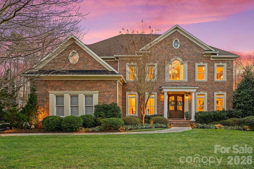 Gracefully positioned on nearly half an acre at the end of a coveted cul-de-sac in the desirable Enclave of Brookhaven, this exceptional full brick estate offers over 6,500 square feet of refined living in a community prized for its resort-style amenities and access to highly regarded schools.  This John Wieland Colonnade home is designed for both elegant entertaining and everyday comfort, this home delivers luxury, flexibility, and an elevated lifestyle just minutes from downtown Matthews. A grand two-story foyer sets a stunning first impression, highlighted by a dramatic circular staircase that anchors the home with timeless architectural elegance. At the heart of the home, a gourmet kitchen anchors the main level, seamlessly opening to a dramatic two-story great room filled with natural light. A sun-drenched sunroom provides a serene space to unwind, while a main-level guest suite offers privacy and convenience for visiting family or extended stays. The primary suite is a true retreat, featuring a versatile flex space ideal for a private sitting room, home office, or wellness studio. Additional bedrooms and baths are thoughtfully arranged to support both daily living and gracious hosting.The fully finished walk-out basement is perfectly suited for multi-generational living complete with a second kitchen, spacious living area, and a second laundry offering the comfort and independence of a private residence while remaining connected to the home. Outdoor living rivals that of a private resort. The tree lined backyard oasis showcases a saltwater gunite pool and spa, a covered paver patio for year-round entertaining, and a tranquil koi pond, creating an atmosphere of relaxation and retreat. From its resort-style outdoor living to thoughtfully designed interior,  this home presents an unparalleled opportunity to enjoy luxury living in one of the area's most sought-after communities.