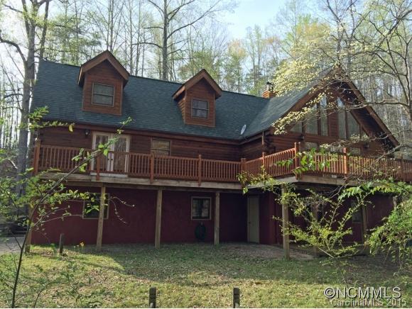 Classic log cabin on quiet, wooded cul-de-sac, with stone fireplace, split bedroom plan, lots of decks looking into the woods, covered front porch, 2 car garage and lots of storage space in basement. Small creek in back. Furnishings negotiable to easily make this a vacation rental with access to all the amenities of Rumbling Bald Resort. Recent home inspection available, $4,500 closing allowance for repairs.