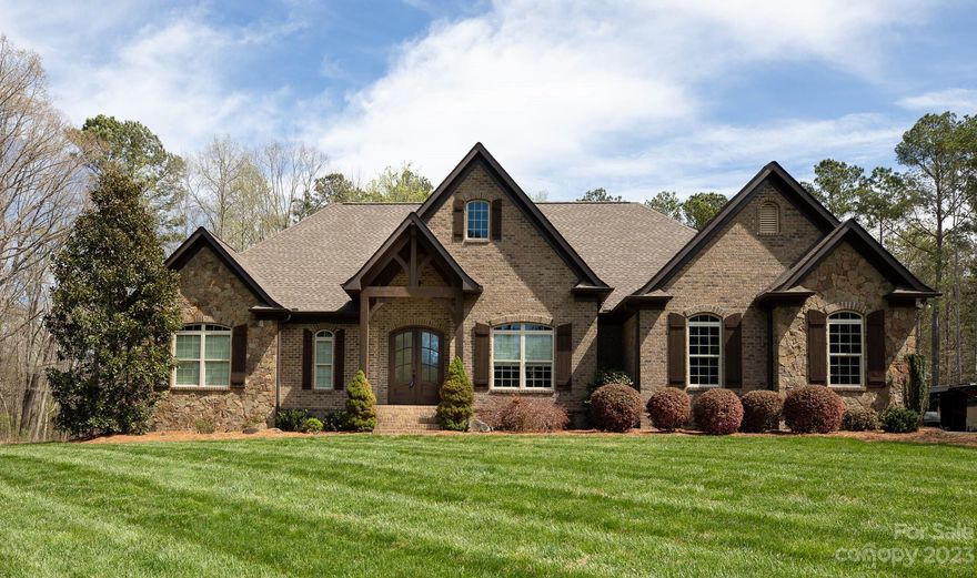 Your luxurious dream home awaits! Blending the comforts of home with an outdoor oasis, this gorgeous brick with stone home is poised on 7 AC of land featuring a tranquil and private setting for relaxation and recreation! The picturesque design and style of the interior focuses your attention to every aspect of this home. Inspired for meals to be shared, this kitchen features functional prep space, granite counters, spacious cabinetry along with island and breakfast bar that opens to a dining area with a great view plus a formal dining room. The primary suite with ensuite featuring large walk-in shower and dual vanities. Slip away into the beautiful in-ground pool or get cozy in one of the many relaxing spots in your own backyard retreat with palm trees, landscaping and stone fireplace plus irrigation in yard. There's a 30x50 metal building for a workshop, 2 car attached garage and RV parking with sewer, water and power hookup! Add in the Clover School District - this truly has it all!