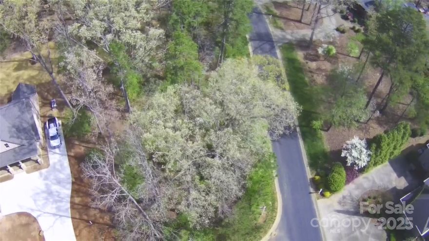 Discover the perfect setting for your forever home on this nearly half-acre wooded corner lot, offering serene water views in a secure gated Uwharrie Point community. Enjoy privacy and nature while being part of a vibrant neighborhood featuring a clubhouse filled with activities and amenities. Top-rated Tom Fazio-designed championship golf course, Marina, clubhouse, tennis courts, pickleball, pools, putting greens, walking trails, and opportunities to join the Old North State golf, tennis, and dining club are a few features. Don't miss this rare opportunity to build your dream home in an ideal location.