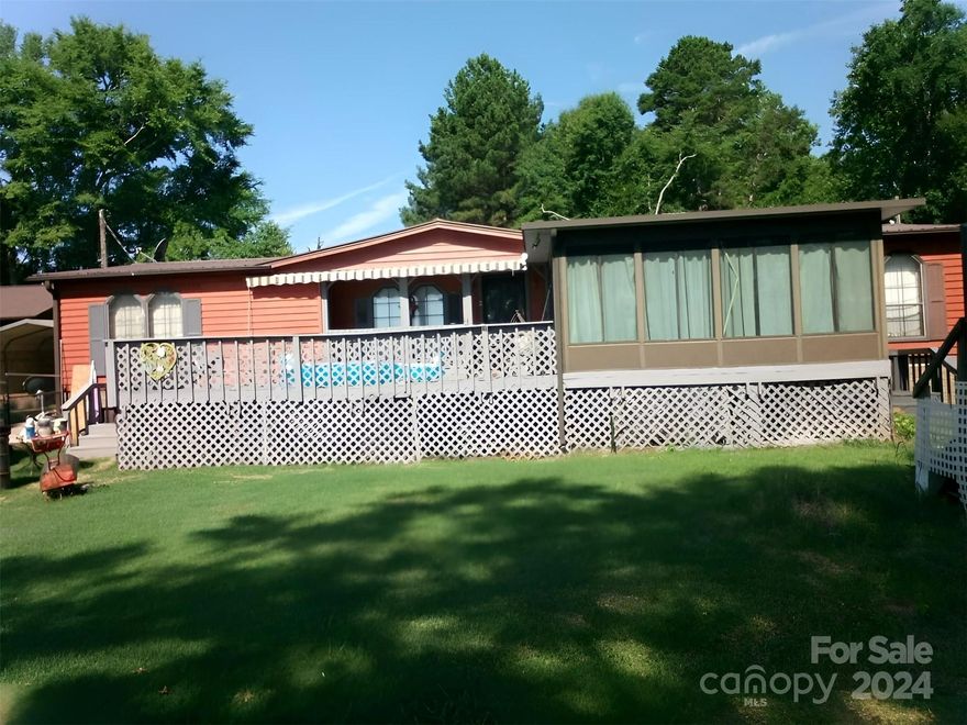 Fresh on the market!! Waterfront property on High Rock Lake! Escape and live in this beautiful setting. 3 bedrooms and 2 full bathrooms, covered sunroom, well-sized back deck that will leave you looking out at the water every time you catch a glimpse. Grab a beverage and step out onto the floating dock on one of the best fishing lakes in all of NC. Primary bathroom has a large soaking tub. Hardwood flooring through common areas. 0.40 acre property with a storage shed. This as-is double-width manufactured home is on a permanent foundation. Newer metal roof installed already. You have to see this view to believe it. CALL to schedule your walkthrough while you can!