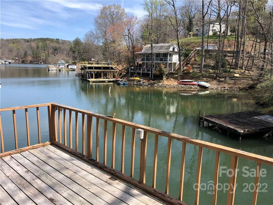 Great lakefront building site with a single-boat boathouse and a 1-slip covered dock to the side already in place! Convenient location close to shopping, downtown Lake Lure and Chimney Rock. The original home burned down years ago, so there is already a cleared area where the old foundation sits. Engineering plans for a new 3 bedroom 2 bath home are available & included with the sale. There are also stairs already installed from the parking area leading down to the homesite. Come build your new home without a lot of the startup hassle and start living the “Lake Life!’’