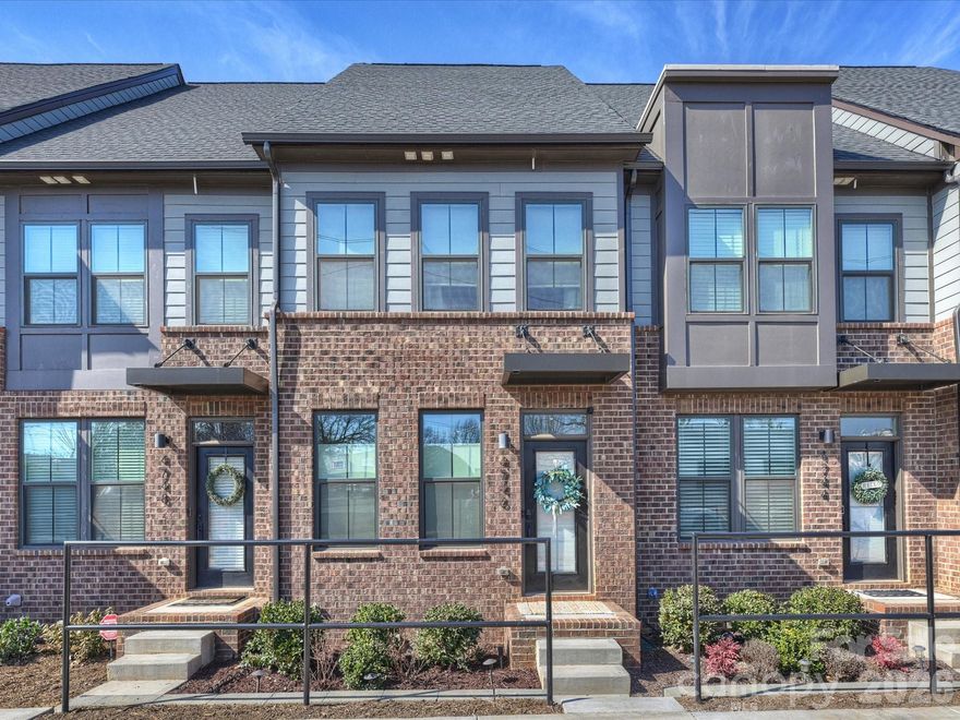 Enter from the street into a spacious living room that flows seamlessly into a chef’s kitchen featuring white cabinetry, quartz countertops, stainless steel appliances. The adjacent dining area opens to a private balcony - perfect for morning coffee or an after-dinner cocktail. Upstairs, the expansive primary suite offers like-new carpet, a tray ceiling with fan, and an oversized walk-in closet. The spa-inspired primary bath features a dual vanity with quartz countertops and a large walk-in shower. A secondary bedroom also includes a walk-in closet and en-suite bath. The top level boasts a rare, true third bedroom with an en-suite full bath, closet, and direct access to the outdoor rooftop terrace—ideal for entertaining or relaxing. Custom window treatments are featured throughout the home. This like-new townhome offers easy access to Charlotte Douglas International Airport and South End, combining modern living with unbeatable convenience.