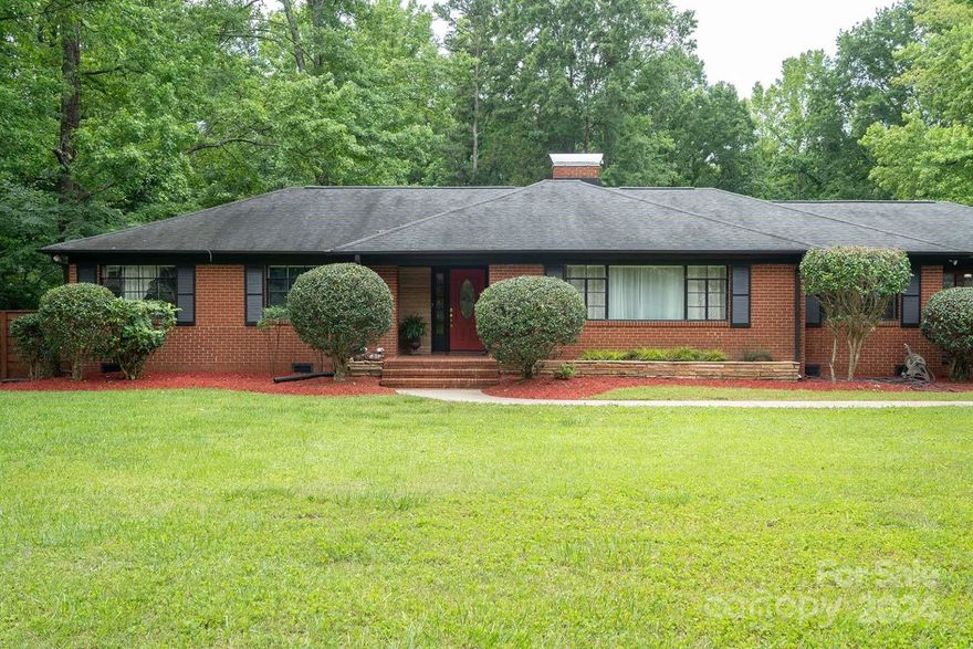 Welcome to this exceptional 3-bedroom, 2-bath home, ideally located on over 3 acres of lush land in Charlotte. This beautifully renovated residence boasts real hardwood floors, a fully updated kitchen featuring elegant quartz countertops, a spacious island with a cooktop, stylish pendant lighting, an electric double oven, a touchscreen Samsung refrigerator, and a built-in mini wine fridge. Enjoy panoramic views flooding the space with natural light. The guest and master bathrooms, along with the laundry room, have been thoughtfully renovated. Step outside to a massive deck, perfect for entertaining, and a fenced area ideal for pets. The backyard retreat includes a fire pit, pergola, and ample seating. Desirable fiber optic cable internet is available. Sold with all furnishings included, ensuring a turn-key experience.
This prime location blends suburban tranquility with urban convenience. Just 15 minutes to uptown Charlotte, 20 minutes to Concord Mills Mall, and 10 minutes to Highway