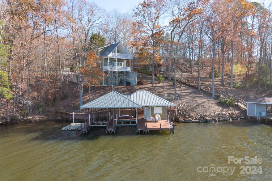 Stunning main channel views with amazing sunsets at this Lake Tillery waterfront home. Three bedrooms and three full baths. The primary bedroom is on the upper level with a walkout balcony and lots of glass on the lake side. Double slip boathouse with bar and stoarge. Deep water with an approximate depth of 10 feet or more. Walkout deck from the main level and patio at the basement. The basement offers a great room with a bunk bed area if extra sleeping space is needed. The laundry is in the basement mud room along with tons of storage in an over 200 s/f room. Best of all the property will convey fully furnished with the exception of only a few personal items. Come find your place on Lake Tillery and start enjoying Lake Life at It's Best !!!!
