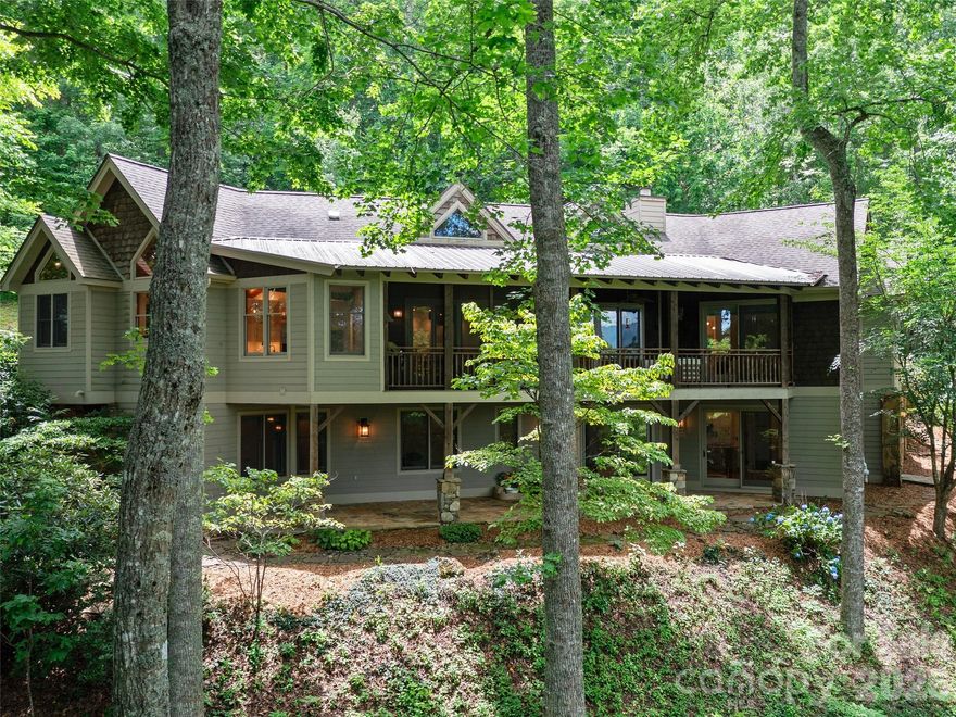 In the sought-after Swiss Pine Lake neighborhood, this renovated Contemporary Craftsman on a quiet hilltop
offers private, seasonal mountain views, with trails, waterfalls, a lake, and golf course nearby. Inside, ambrosia maple floors, vaulted cherry ceilings, and a stone fireplace define the great room. The reimagined main-level primary suite features a massive walk-in closet with an island and a spa-style bath with a garden tub, steam shower, and radiant heated floors. The gourmet kitchen opens to a screened porch with a built-in BBQ. The main floor also includes a spacious pantry, a flex room used as a nursery, and a private office above the garage. The lower level offers a family room with fireplace, two en-suite bedrooms, a playroom, and a home gym. A rare find just minutes from the Blue Ridge Parkway and downtown Spruce Pine.