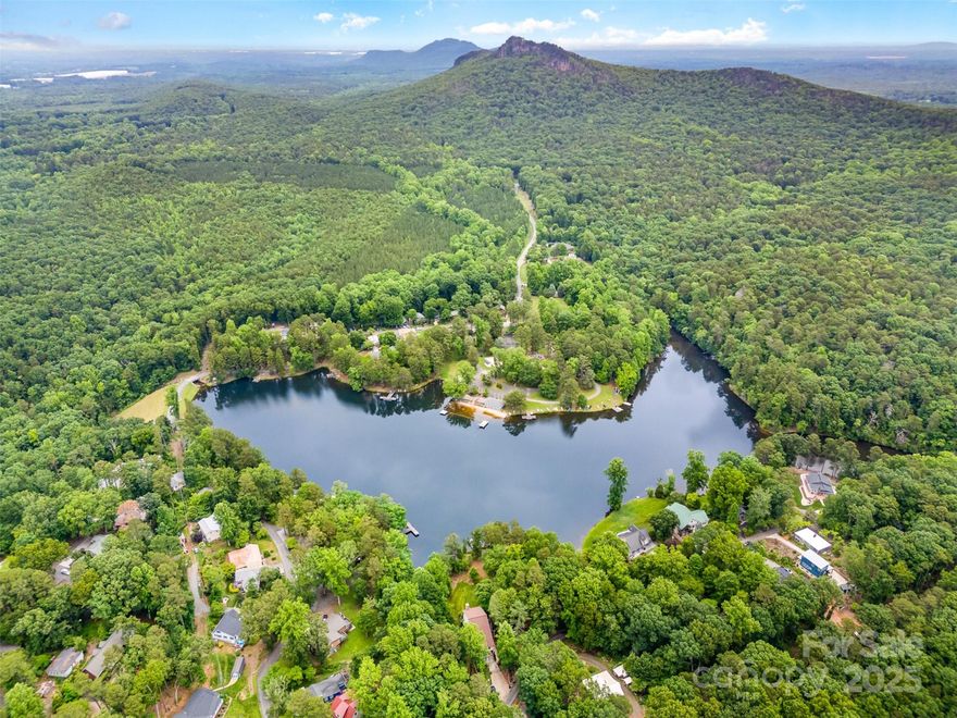 Tucked away in a peaceful private community on Lake Montonia, this 3BR/2BA home offers exclusive lake access with a sandy beach, picnic area, and calm waters perfect for swimming or paddling. The property sits on a beautiful, wooded lot surrounded by protected land from Crowders Mountain State Park, ensuring privacy and natural beauty that will never be developed. Inside, the home offers a solid structure and generous space, ready for a thoughtful renovation to maximize its full potential. Outdoor enthusiasts will love having hiking, rock climbing, fishing, and breathtaking overlooks just minutes away via the Pinnacle and Ridgeline trails. A unique chance to enjoy quiet lakeside living with endless access to nature.