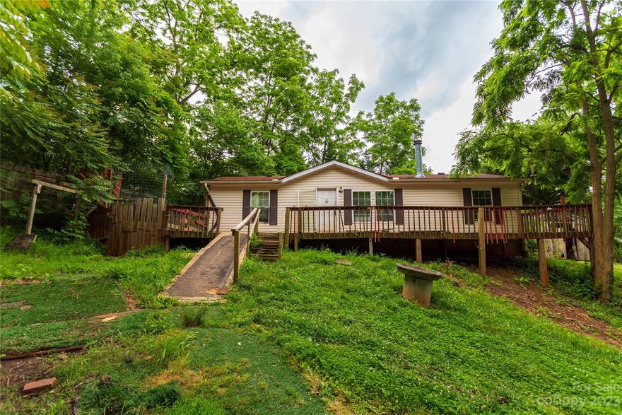 .31 Acres in the Middle of Oakley with a 3/2 Modular, (according to Buncombe County Tax Record) 1300sf plus, that is in need of new flooring and painting and some TLC too!  Property is being sold BELOW tax value to accommodate updates.  Here is a chance for your buyer to own a decent place for under $250,000.