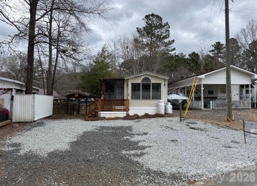 Welcome to your lake getaway at Twin Harbor, whether you are seeking full-time residency or needing the perfect Lake Tillery getaway, this place covers all bases.  Fresh gravel was just added and a tree removed to increase parking space! This park model with sunroom addition is ready to move in and has undergone a remodel with fresh paint throughout the interior, freshly stained decks, new LVP flooring and fixtures. The community is one of a kind. Some features of the community include: a pool, community store, cafe, arcade, basketball court, church, putt-putt golf area, playgrounds, a beach area on the lake, multiple boat ramps, pickleball court and tons of entertainment throughout the year. The community has a gated entrance and 24-hour security.