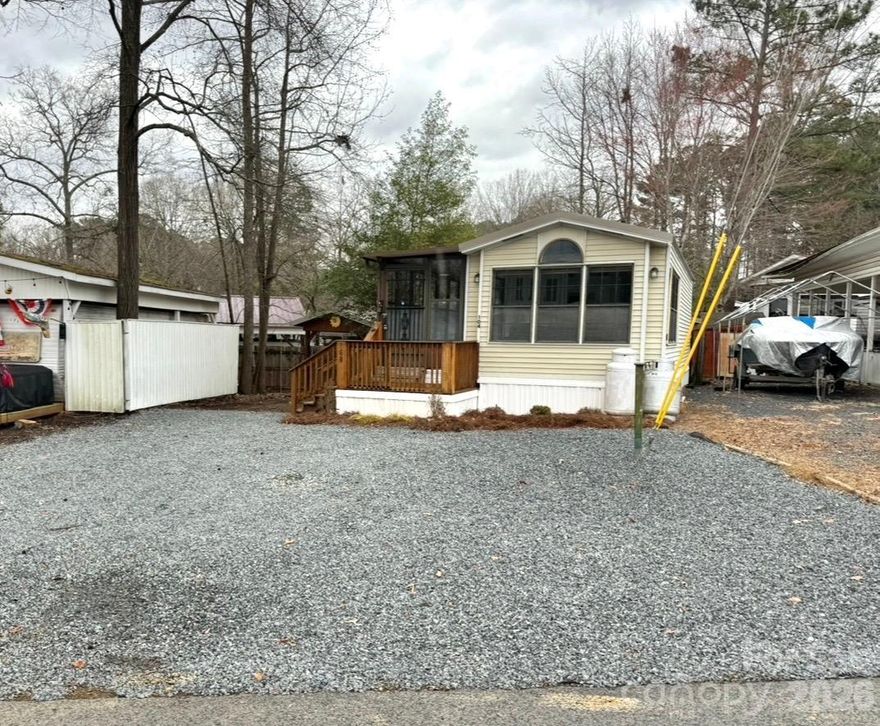 Welcome to your lake getaway at Twin Harbor, whether you are seeking full-time residency or needing the perfect Lake Tillery getaway, this place covers all bases.  Fresh gravel was just added and a tree removed to increase parking space! This park model with sunroom addition is ready to move in and has undergone a remodel with fresh paint throughout the interior, freshly stained decks, new LVP flooring and fixtures. The community is one of a kind. Some features of the community include: a pool, community store, cafe, arcade, basketball court, church, putt-putt golf area, playgrounds, a beach area on the lake, multiple boat ramps, pickleball court and tons of entertainment throughout the year. The community has a gated entrance and 24-hour security.