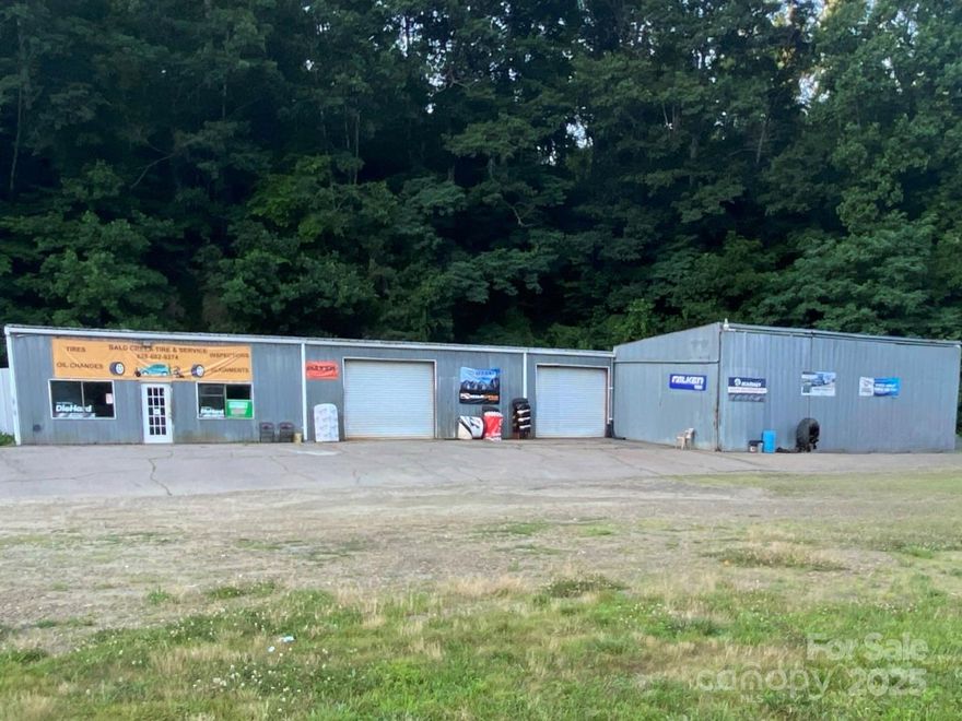 Prime Commercial Property with Established Tire and Auto Service! Here’s an incredible opportunity to own 4.28 acres of commercial land on busy US Highway 19 in Burnsville. This corner lot comes with a fully operational tire shop boasting a loyal customer base and steady daily traffic, making it ideal for continued business or future ventures. The property includes a spacious service area with multiple bays, a large lobby with restrooms, and ample parking for customers and deliveries. All shop equipment, office supplies, and inventory are included, offering a complete turnkey operation. Behind the shop, the remaining 2.97 acres provide room for building a residence, expanding commercial space, or pursuing new business ideas. Whether you’re an investor, developer, or entrepreneur, this property is packed with potential for growth and redevelopment in a prime location.