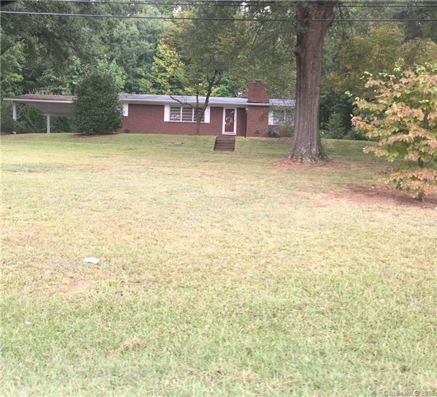 Nice brick 3 bedroom / 2 bath home with a garage in the basement plus a wrap around driveway and 2 car carport. Great Yard.  Close to schools.