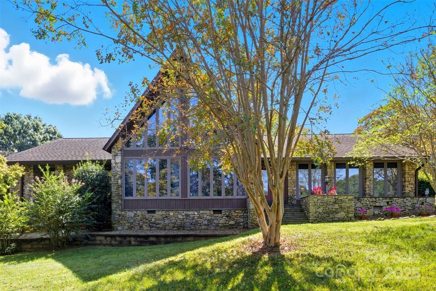 Nestled within the exclusive gated community of Heatherloch, this exquisite lake view residence exudes timeless elegance and craftmanship. Constructed with stone sourced from the same quarry as the renowned Biltmore Estate, the home's exterior and interior radiates sophistication and durability. Step inside to discover lustrous bamboo hardwood floors complemented by one-inch thick, tongue-and-groove V grooved oak paneling adorning the walls, creating a warm and inviting ambiance. At the heart of the living room stands a majestic 16-foot-wide stone fireplace, a stunning wood-burning centerpiece with optional gas assist and a custom-crafted mantle, perfect for cozy gatherings. The primary bathroom is a sanctuary of indulgence, highlighted by a beautiful porcelain-coated cast iron tub that adds a touch of vintage charm. The meticulously renovated kitchen is a chef's dream, boasting custom granite countertops, bespoke cabinetry with convenient pull-out drawers, and a thoughtfully designed pantry wall for seamless organization. The bathrooms have been transformed with luxurious vanities, featuring elegant granite and quartzite finishes that elevate the space. This remarkable home offers unparalleled living spaces and breathtaking lake views, presenting a rare opportunity to own a residence of such distinction and character. You do not want to miss the chance to experience this home's extraordinary allure.