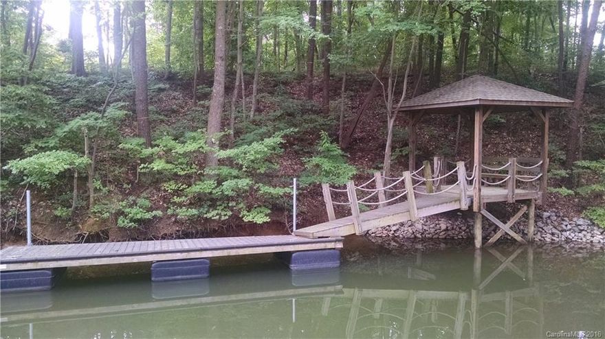 Great Waterfront Building Lot with Great Trees on .75 Acres.  Enjoy Your Own Personal Dock with Sitting Area and Access to Water Fun While Construction On Your New Home is Underway!  Peaceful Views!  Decking Made of Brazilian Hardwood Known as Ipe.  Pier is Tagged and Approved by Duke Energy.  Stabilized shoreline.  Location  Allows You to Get Away from it All but Remain Close to Shopping and Restaurants.  New Villages of Sherrills Ford Complex Being Constructed Nearby!  Publix Coming Soon!