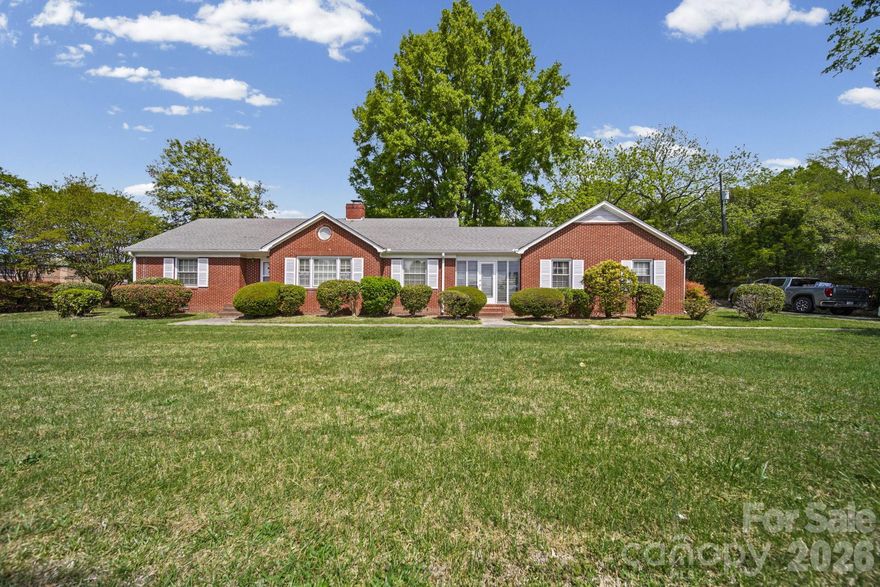 Well-maintained brick home situated on approximately 0.49 acres with excellent Highway 74 road frontage in Marshville, NC. Built in 1949, this inviting one-story residence blends classic character with versatile living space.

The home features 2 bedrooms and 1 full bath, along with two separate living rooms—each with its own fireplace—offering flexible options for relaxing or entertaining. The property has been cared for over the years and reflects true pride of ownership.

An enclosed breezeway connects the main home to a spacious bonus/office area. The enclosed garage, complete with a fireplace and built-in bookcases, provides additional living or workspace potential and could easily serve as a home office, den, or bonus room. A dedicated storage room is also attached for added convenience.

Step outside to enjoy the fenced backyard, perfect for pets, gardening, or outdoor gatherings.

Zoned TMU (Transitional Mixed Use), this property offers exceptional flexibility for residential, retail, and/or commercial use—making it a unique opportunity for homeowners, business owners, or investors alike. With its prime Highway 74 frontage and adaptable layout, the possibilities are endless.