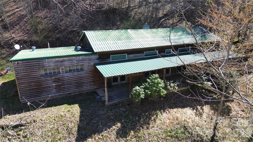 Discover the perfect blend of privacy, potential, and pristine Western North Carolina mountain living at 17619 NC 209 Highway, Hot Springs, NC 28743—a rare opportunity on 12.6 sprawling acres in the serene Spring Creek community.

This spacious 3-bedroom 2-bathroom home was built in 1975 and offers a blank canvas for your vision. Currently unfinished in parts, it features multiple flexible spaces that can easily transform into additional bedrooms, bonus rooms, offices, or hobby areas—providing endless possibilities for customization. The open-concept layout invites natural light through generous windows, while the solid bones include a practical slab foundation, good electrical condition, and convenient detached garage parking.

Step outside to your own private paradise: the expansive wooded and open acreage delivers ultimate seclusion, with room to roam, garden, add trails, or create your dream outdoor retreat. Just across the road, the soothing sounds of babbling Spring Creek create a tranquil backdrop—ideal for relaxing on the expansive covered front porch, fly fishing, or simply unwinding amid nature's symphony.

Nestled in the heart of Madison County's mountain charm, this property is a short and beautiful drive from historic Hot Springs' famous mineral baths, the French Broad River for rafting and tubing, Appalachian Trail access, hiking trails, and the vibrant yet laid-back downtown scene. Zoning supports versatile uses, including potential for accessory dwellings, guest cabins, or even a family compound—making it a smart choice for those seeking a legacy property or income-generating retreat.

Sold AS-IS and ready for the right owner to infuse creativity and sweat equity. Whether you're envisioning a forever mountain home, multi-generational haven, or high-potential investment, this rare large-acreage gem in a peaceful, creek-side setting won't last long.

Schedule your private tour and start turning this mountain canvas into your masterpiece!