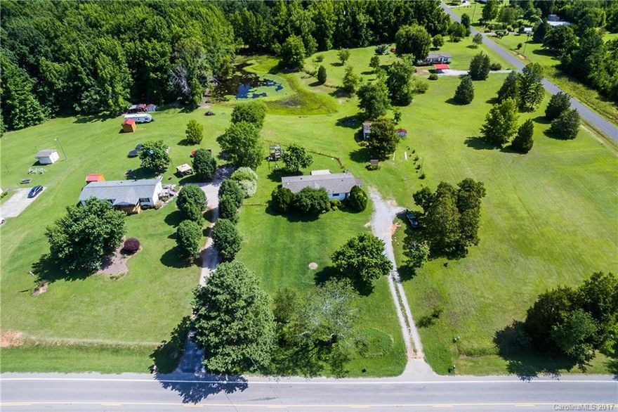 Nearly 3 acres of land with a pond! Charming 3 bedroom 2 bath home with new carpets. Great kitchen with kitchen island and dining area. Freshly painted split bedroom floor plan with good sized bedrooms and large closets. Sit on the back deck and enjoy your own land or grab a fishing rod and do some fishing in your backyard!