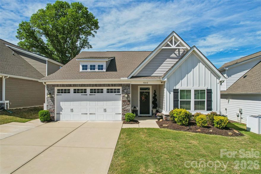 Step into easy, elevated living in this beautifully designed newer home located in a 55+ community. Offering 4 bedrooms and 3 full baths, this home blends modern comfort with thoughtful design, perfect for both everyday living and entertaining. The open-concept floorplan welcomes you with natural light and seamless flow between the living, dining, and kitchen areas. At the heart of the home, an oversized island anchors the kitchen, complemented by stainless steel appliances, ample cabinetry, and stylish finishes. 
The living room is highlighted by a dramatic floor-to-ceiling stone gas fireplace that creates a warm and sophisticated focal point. Step outside to enjoy the screened-in porch or host gatherings on the expansive stamped concrete patio. The spacious bedrooms provide flexibility for guests, hobbies, or a home office, while the main floor primary suite offers comfort and privacy. Home also features a tankless water heater and added electrical panel allowing you to hook up a generator if power is lost.  Beyond the home, amenities including a community pool and maintenance-free lawn care covered by the HOA. This home delivers the perfect balance of style, comfort, and low-maintenance living-don’t miss your opportunity to make it yours.