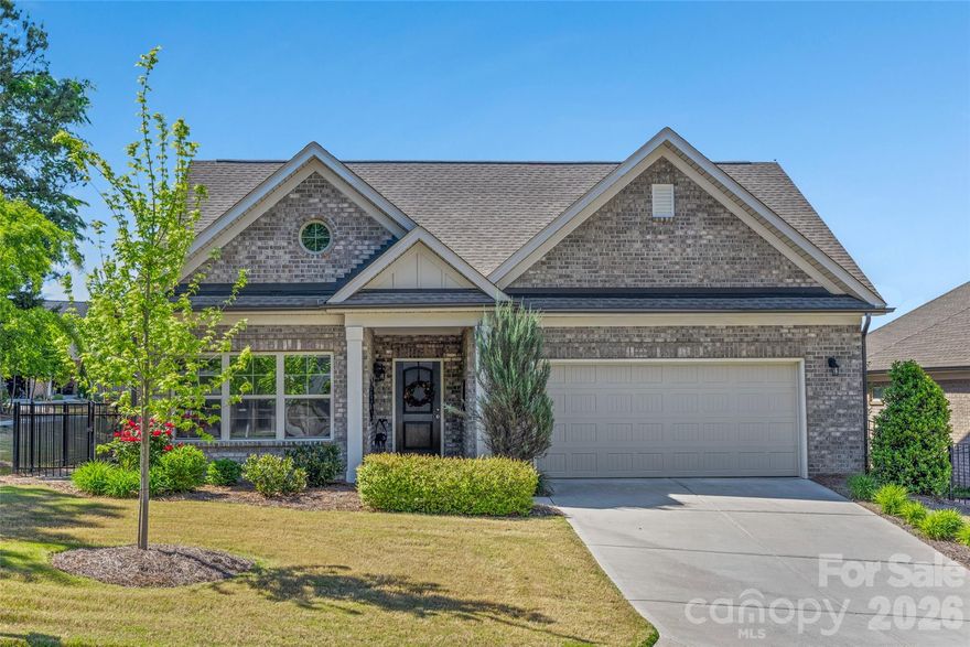 Welcome to this beautifully designed patio home in a 55+ community, where lawn care is included for easy, low-maintenance living. Featuring tall ceilings throughout and an open floor plan, this home offers a bright and spacious feel. Tray ceilings in the primary suite, dining room, kitchen, and great room add an elegant touch, while large windows bring in natural light to the great room, dining area, and primary bedroom. The kitchen is both stylish and functional with granite countertops, a large island with seating, under-cabinet lighting, a pantry, a stainless steel sink, a glass top electric stove, a microwave, and all appliances, including a washer and dryer, are included. It flows seamlessly to the dining room and great room, making it ideal for everyday living and entertaining. The primary suite offers a peaceful retreat with generous windows, a walk-in closet, and an ensuite bath featuring a tiled Roman shower, double sinks, a water closet, and linen storage. The second bedroom is part of a split bedroom plan, offering privacy from the primary suite. Both bedrooms have carpet, and the second bath includes tile flooring, a tub, and a single sink. Additional features include a dedicated office, laundry room, and extra storage space. Enjoy outdoor living in the fully fenced backyard, complete with a water fountain and oversized umbrella that will remain. The large garage provides ample space, and all the amenities in Tega Cay are available to the owners: Club House, Game Court, Golf Course, Lake Access, Outdoor Pool, Picnic Area, Playground, Putting Green, Recreation Area, Sport Court, Street Lights, Tennis Court(s), Walking Trails. The HOA has plans to add a community pool, offering even more to enjoy.