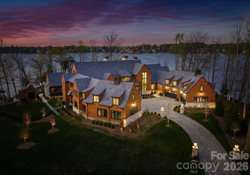 Step through the front door and you immediately feel it—total privacy, panoramic water views, and a level of craftsmanship rarely seen on Lake Norman. Set on its own gated 3.04-acre island with approximately 1,250 feet of shoreline, Regatta Island offers a rare combination of scale, exclusivity, and turnkey luxury.

Finished with wide-plank white oak flooring and a premium appliance package featuring Wolf appliances and a Sub-Zero refrigerator, the home blends refined design with top-tier performance. The double-island chef’s kitchen anchors the main living space, flowing seamlessly into expansive indoor and outdoor entertaining areas.

Slide open the doors and transition instantly into resort-style living, where a saltwater pool and spa overlook the water, complemented by fire features and a covered lakeside pavilion designed for year-round enjoyment. A custom pool house and an exceptional private dock by Lyfe Marine — complete with covered boat storage, multiple lifts, and jet ski platforms—create a true waterfront retreat.

Whether enjoying the lake from your private shoreline or heading out for the evening, the property offers both seclusion and convenience—choose your vehicle from the 8-car garage or step onto your boat within seconds.

Completed in July 2024 by King Farm Building Group, this fully furnished estate was designed for effortless indoor-outdoor living and elevated entertaining. Additional features include two Generac generators, two laundry rooms with Electrolux washers and dryers, a Savaria Eclipse elevator, six Daikin HVAC systems, three Navien tankless water heaters, and dual pump-out systems to the road.

Architectural details include Windsor Pinnacle aluminum-clad windows, Charleston blend slate roofing, a custom Clark Hall iron entry door with rain-tempered glass, North Carolina quarried stone, multiple Isokern fireplace systems, and custom copper chimney shrouds. The motor court is finished with Belgard Lafitt Grana slab pavers and Belgian block accents.

A truly rare opportunity to own a fully realized private island compound where every detail has been designed for an exceptional waterfront lifestyle.

All showings by appointment with listing agent. Proof of funds required.