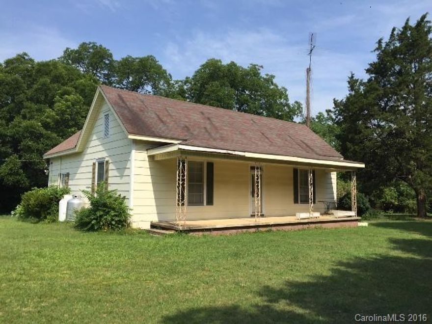 Country farmhouse sitting on over 7 acres! Covered front porch, large deck overlooks beautiful yard! Great starter home or investment opportunity! Just needs a little TLC! SOLD AS IS AND CASH ONLY!