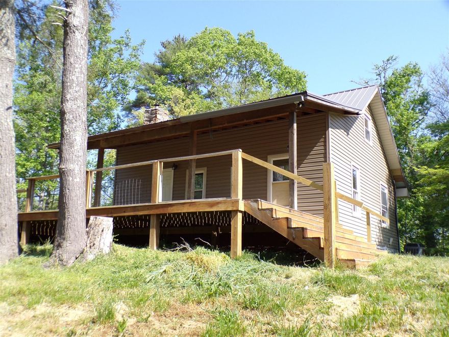 This rustic mountain home with 728 SF includes 6 acres and a partially covered 15 x 28-foot rocking chair deck overlooking the hills.  The interior offers a step-saver kitchen, a living room with a stone fireplace, and a main-level bedroom with no closet, with an adjoining laundry room.   The finished attic, with a ceiling height under 7 feet, offers the possibilities of additional storage, an office, or a hobby area.  This property is located off a privately maintained road with no turnaround, and may not be suitable for all vehicles. Due to the condition of the road and to be respectful of the neighbor, drive-by viewing is not possible.  Please schedule showings through your Realtor.  A new property owner will need to establish a road agreement with the property owner located at 82 Honor Lane, Hendersonville, NC.  This property also needs a well, and the list price reflects the current condition and the lack of a water source.  Information concerning the septic system, type, or condition is unknown.  The sale of the property is made on an "As Is", Where Is", with all Faults basis, and the seller makes no warranties whatsoever as to the condition of the property or the presence of defects therein, latent or otherwise.  A proof-of-funds letter or cash verification letter is required to submit an offer.  Contact your Realtor today for a showing.