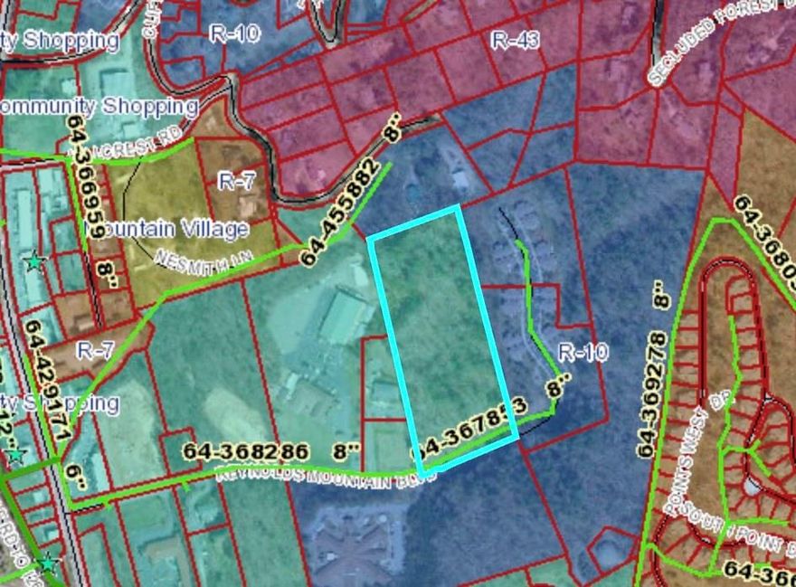 8 acres of Commercially Zoned Property in Woodfin NC. MSD Sewer line is available along the paved city street that borders the property site located within the Woodfin Water District service area. The property has 180 views of the mountains and Asheville, located a block off Merrimon Ave and close to an I-26 interchange.Just 10 minutes from Asheville or Weaverville. The current owner had the property designed, graded, and approved for a 50-lot small home community, complete with roads and stormwater systems in place. Covid delayed plans and now it would need to go before a conditional use zoning for re-approval with the town of Woodfin. Plans are available from the seller. This property offers much potential for commercial, retail, and a variety of service businesses under Woodfin's CS zoning. Could be an ideal spot for multifamily apartments as the property is adjacent to R-10 zoning on three sides.