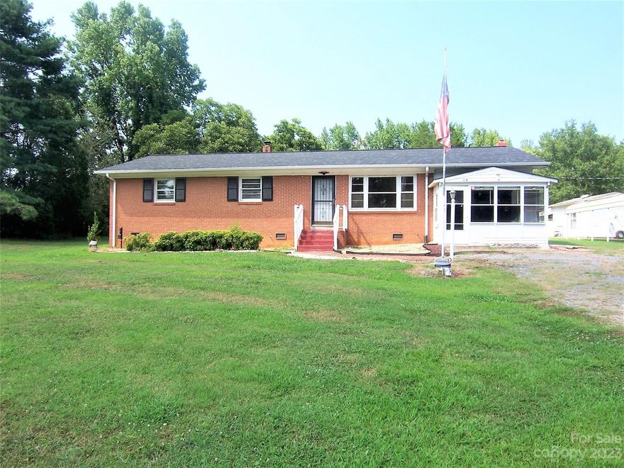 3 bedroom 1 bath brick, wood & vinyl ranch home on 2 parcels totalling approximately 1.54 acre in the countryside. Living Room gets plenty of natural light. Dining Room is large. Kitchen has a breakfast bar & stainless appliances. The refrigerator remains. There is a bonus room. The laundry/storage room is unfinished & not heated. There is an enclosed front porch at the front of the bonus room & a larger enclosed rear porch off of the dining room. There is a flag pole in the front yard & a basketball goal in the back yard. There are numerous outbuildings. There is a detached metal double carport. This home does need some TLC. Being sold cash or conventional only. Being sold as-is; sellers will make no repairs.
