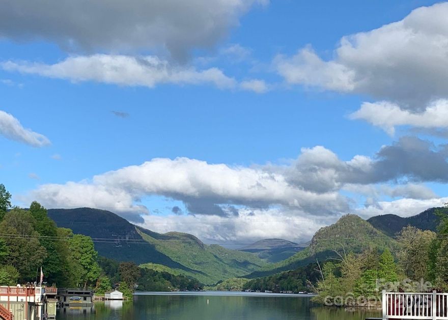 Welcome to a once-in-a-lifetime property — 13.73 acres of lakefront privacy tucked into its own level cove on Lake Lure. This extraordinary estate combines sweeping westerly views of Chimney Rock, incredible sunsets, and minimal steps to the water — a rare find on the lake. 

The main home offers open concept main level living, 4 bedrooms, 2 full baths on the upper level, multiple decks for outdoor living, and spacious parking. A dual-slip boathouse with a rooftop deck and spacious sun deck invites you to fully embrace life on the water. 

A charming studio-style cottage with one bedroom and one bath, connected by a scenic boardwalk, creates the perfect guest retreat or private getaway. Beyond the existing homes, a buildable lot with direct westerly views provides even more opportunity for expansion or future vision.

Whether as a private estate, family retreat, or legacy investment, this property is more than a home — it’s an entire cove of Lake Lure waiting to be yours.