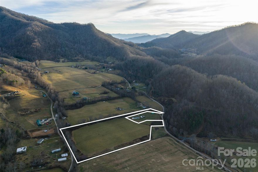 This rare 10-acre parcel of prime pasture land is now available for sale in the serene mountains near Waynesville, North Carolina. Nestled in a private, secluded setting just 20 minutes from vibrant downtown Waynesville, this unrestricted property offers complete freedom for your vision—whether building a custom dream home, establishing a small farm, homestead, or simply enjoying unrestricted mountain living with no HOA, covenants, or zoning limitations to hinder your plans. The entire acreage is remarkably usable and level to a gentle roll on each side ideal for pastures, gardening, livestock, or easy development, with lush open fields ready for immediate enjoyment or improvement. The back portion borders a beautiful flowing creek, providing tranquil water features, potential for fishing or relaxation, and added natural beauty without any known history of flooding to the property ensuring peace of mind in this pristine location. Surrounded by the stunning Blue Ridge scenery, this gem delivers true privacy while remaining conveniently accessible to Waynesville’s amenities, shops, restaurants, and cultural offerings. Don’t miss this exceptional opportunity for unrestricted, all-usable mountain land with creek access in one of Western North Carolina’s most desirable areas.