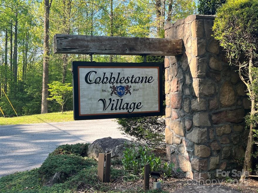 Come build your dream home on this lovely wooded 2.55 acre cul-de-sac homesite in desirable Cobblestone Village. Underground utilities available, paved streets and city water (tap fee required). 4BR septic on file. Located just minutes to the Village of Flat Rock, Flat Rock Playhouse, Carl Sandburg Home and great access to downtown Hendersonville's shopping & dining!
