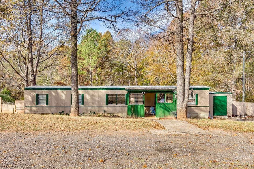 Welcome to Walk A Long Way! Situated on over a quarter acre with a wooded backyard, enjoy a covered porch, back deck, and separate tub and shower in the bathroom. This home gives plenty of opportunity to make it your own, and is conveniently located just minutes from shops, dining, East Gaston High School, Downtown Mount Holly, and the U.S. National Whitewater Center.