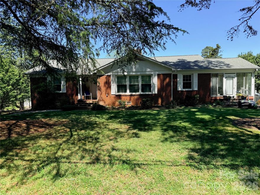 This charming 3-bedroom ranch home sits gracefully on a spacious 0.74-acre corner lot, offering the perfect blend of comfort, style, and privacy. Surrounded by mature trees and open green space, the property provides a peaceful setting with plenty of room to relax or entertain. It is located within walking distance of beautiful Forest City NC. The single-level layout features a bright and inviting living area, a well-appointed kitchen with ample cabinetry, and a cozy dining space ideal for family gatherings. Each bedroom offers generous space and natural light. This home features a full basement with a drive-in garage located on the basement level. Outside, the expansive yard is perfect for outdoor living—whether enjoying morning coffee on the porch, hosting barbecues, or simply taking in the scenic surroundings. With its desirable lot size, corner location, and timeless ranch design, this home delivers both convenience and a warm, welcoming atmosphere.